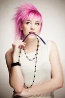 Portrait of Kieran Strange with bright pink hair.