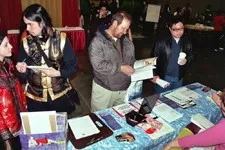 A photo of people sitting at tables during a Kumoricon organizational meeting.