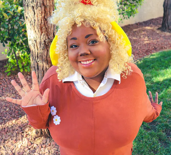 Portrait of Midnight Pursona smiling in an Isabelle (Animal Crossing) inspired outfit.