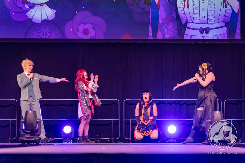 Hosts and performers on stage reacting with excitement during the 2023 winners announcement.