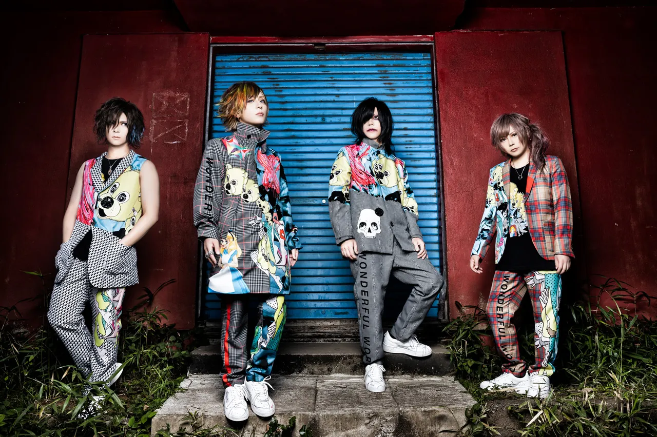 Portrait of the four members of the band ACME posing in stylized, colorful patterned suits.