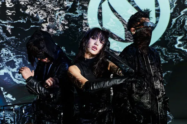 Group portrait of the musical group NOILION in futuristic black outfits.