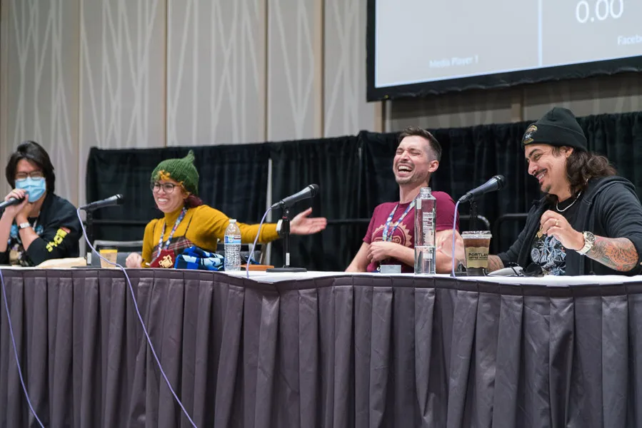 Guests laughing during a Q&A session
