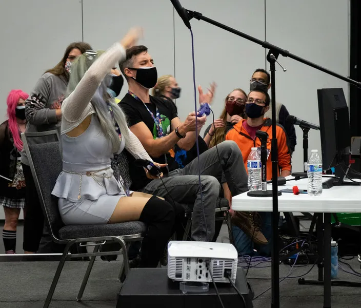 Guests playing video games during a panel