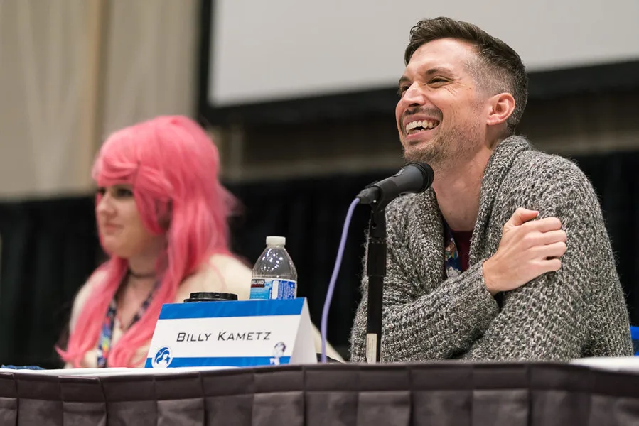 Billy Kametz laughing during a panel