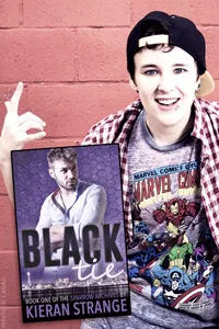 Portrait of Kieran Strange with bright pink hair, wearing a plaid shirt over a white tank top and a backwards cap.